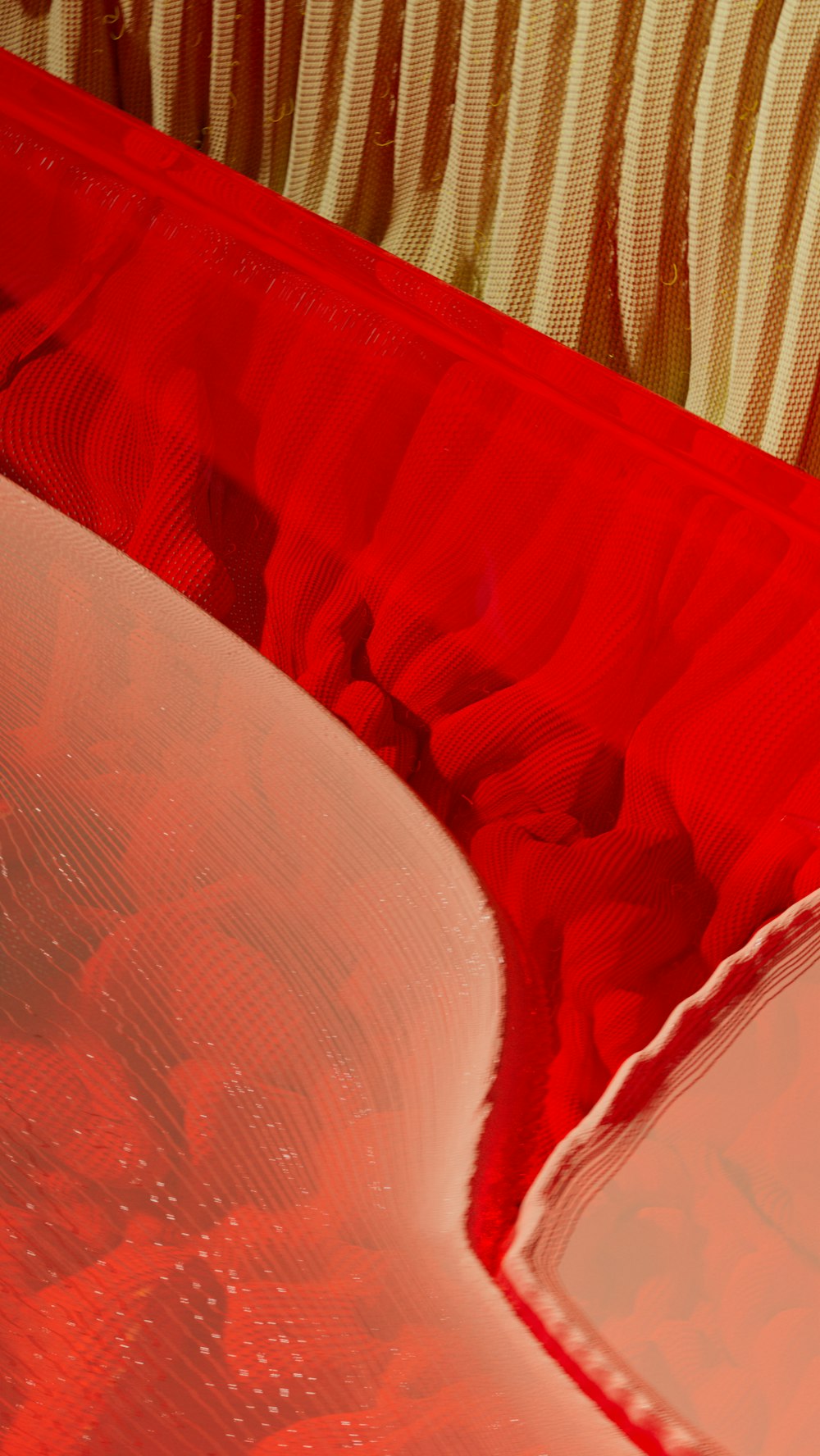 a close up of a red and white table cloth