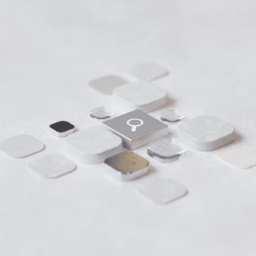 a piece of metal with a button on it