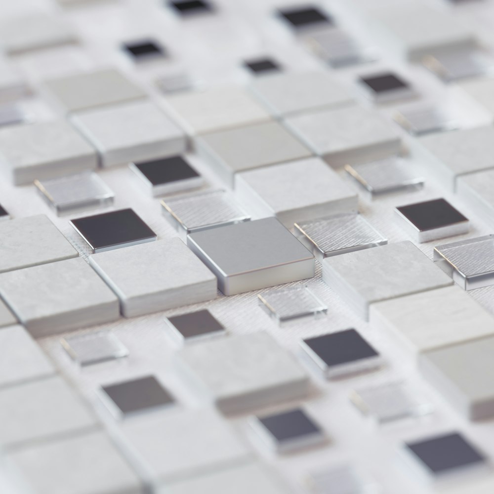 a close up of a white and gray mosaic tile