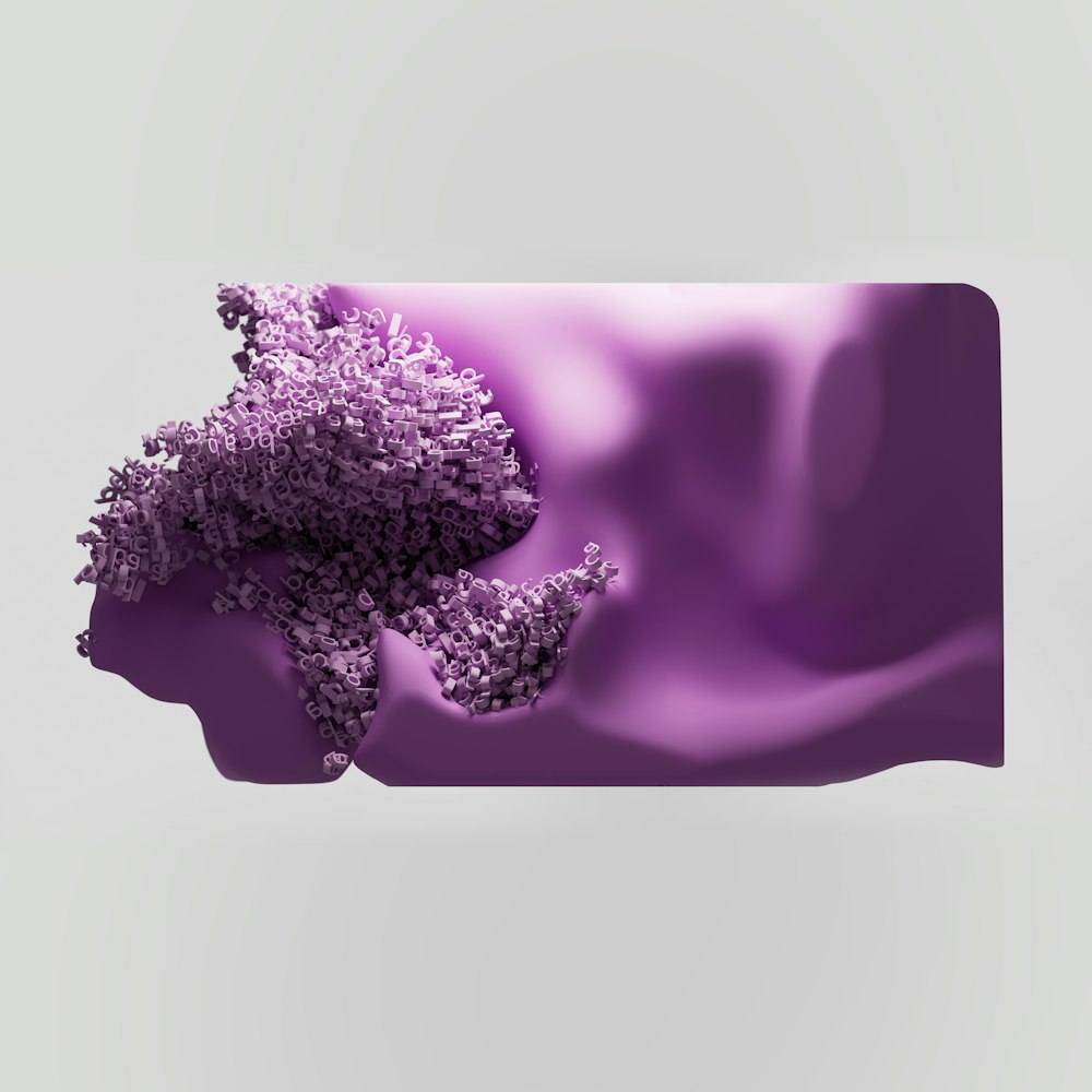 a close up of a purple object on a white background