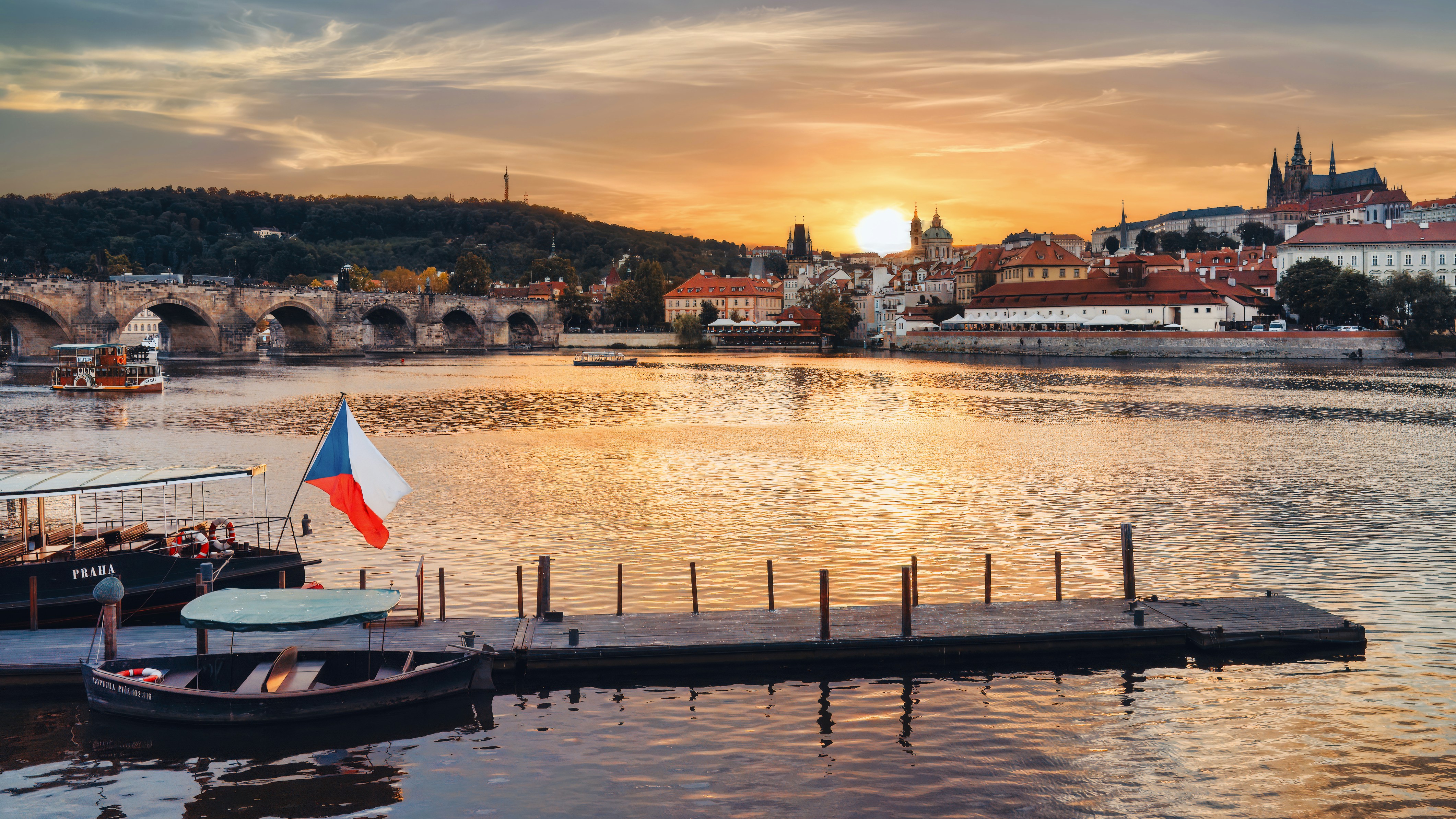 a boat is docked in the water near a bridge