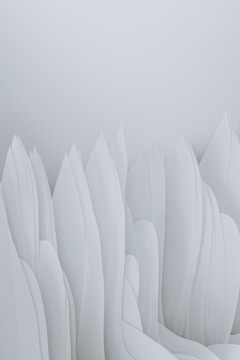 The image features an abstract composition of smooth, flowing forms that resemble elongated, overlapping paper or fabric structures. The soft, pastel tones give the impression of a serene and minimalist landscape.