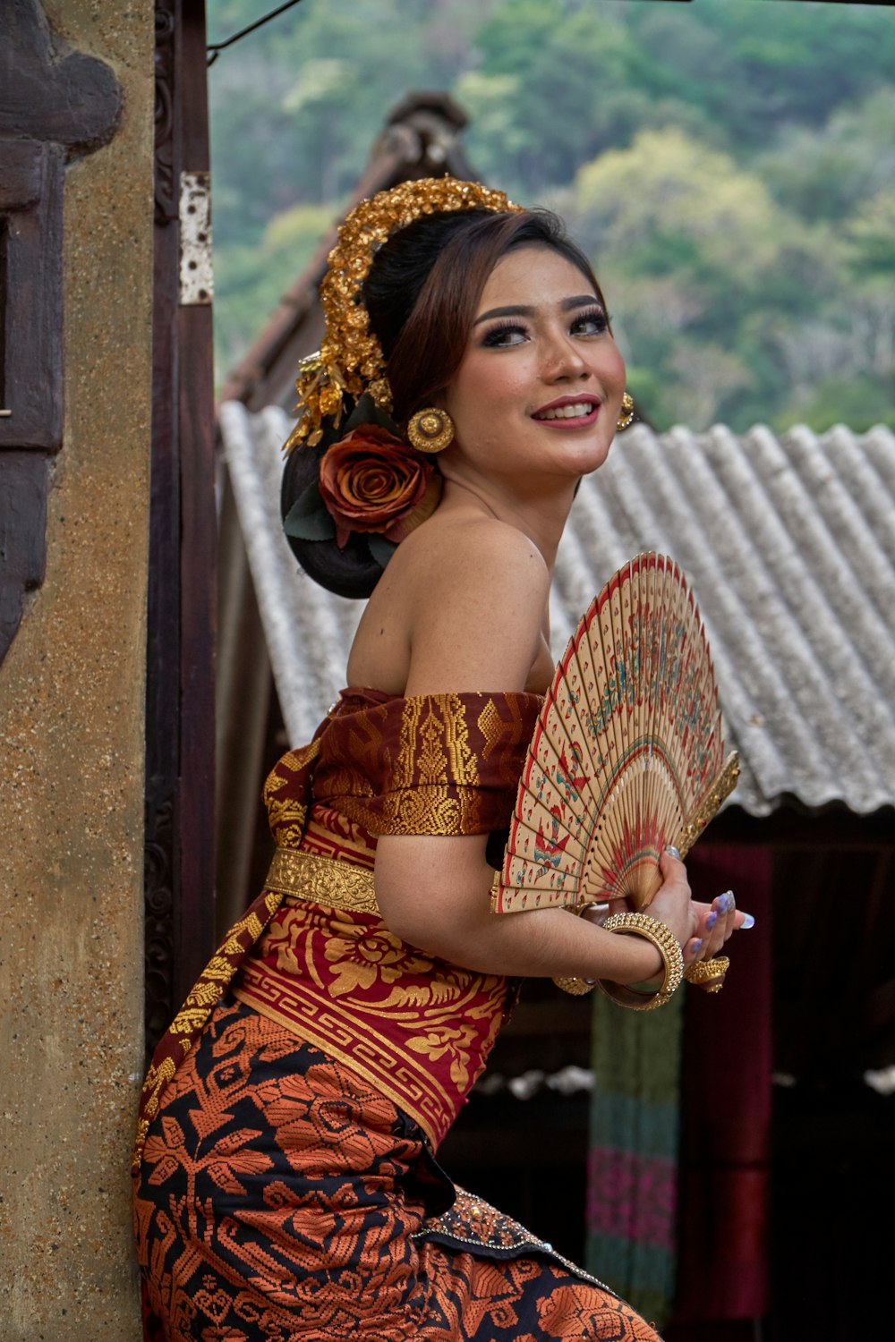 a woman in a dress holding a fan