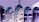 Several test tubes are arranged in a row, reflecting computer code projected onto them. The text appears distorted and split across the test tubes, creating an abstract and futuristic visual effect.