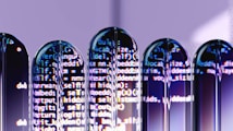 Several test tubes are arranged in a row, reflecting computer code projected onto them. The text appears distorted and split across the test tubes, creating an abstract and futuristic visual effect.