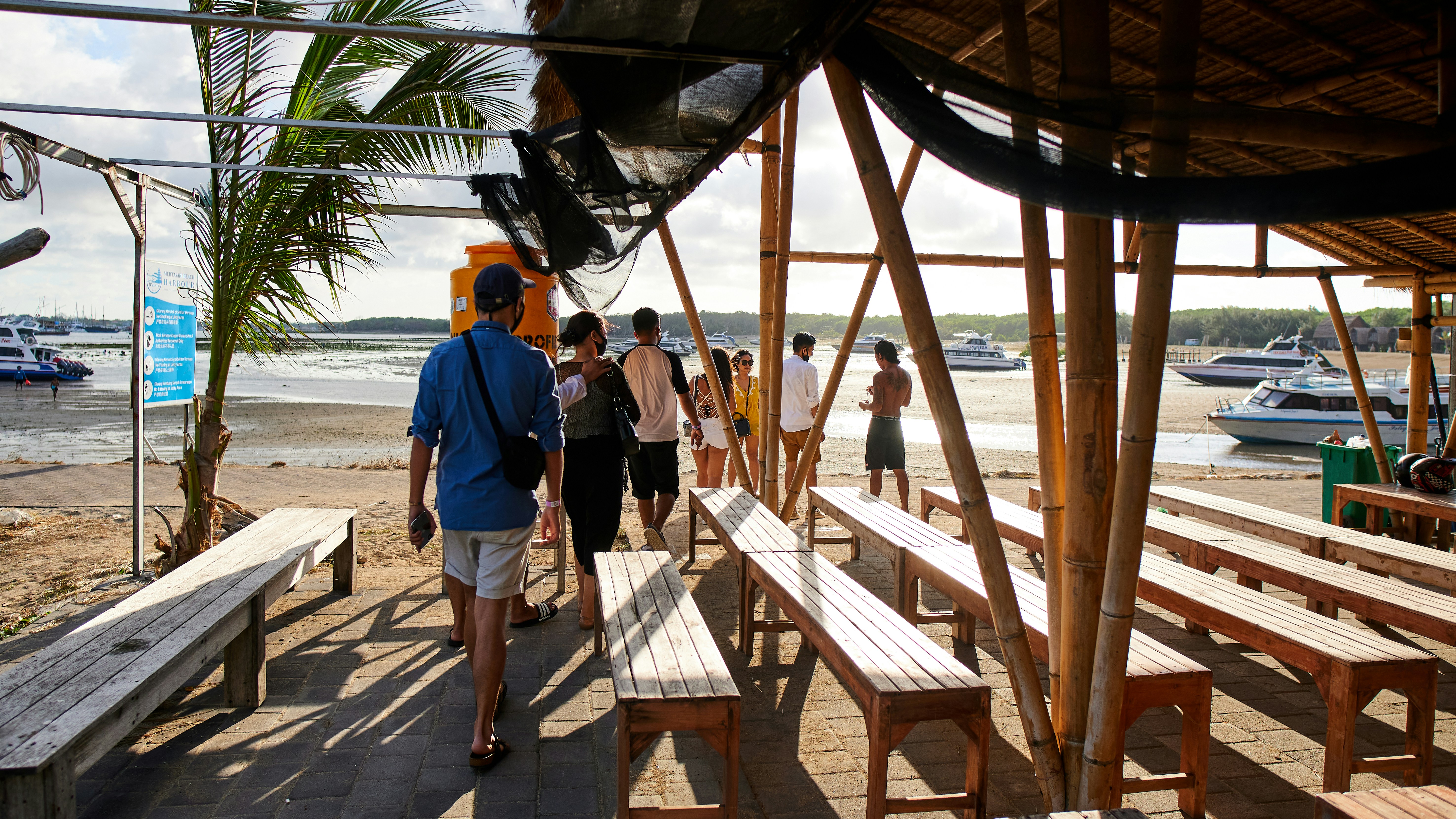 a group of people standing around a wooden bench
