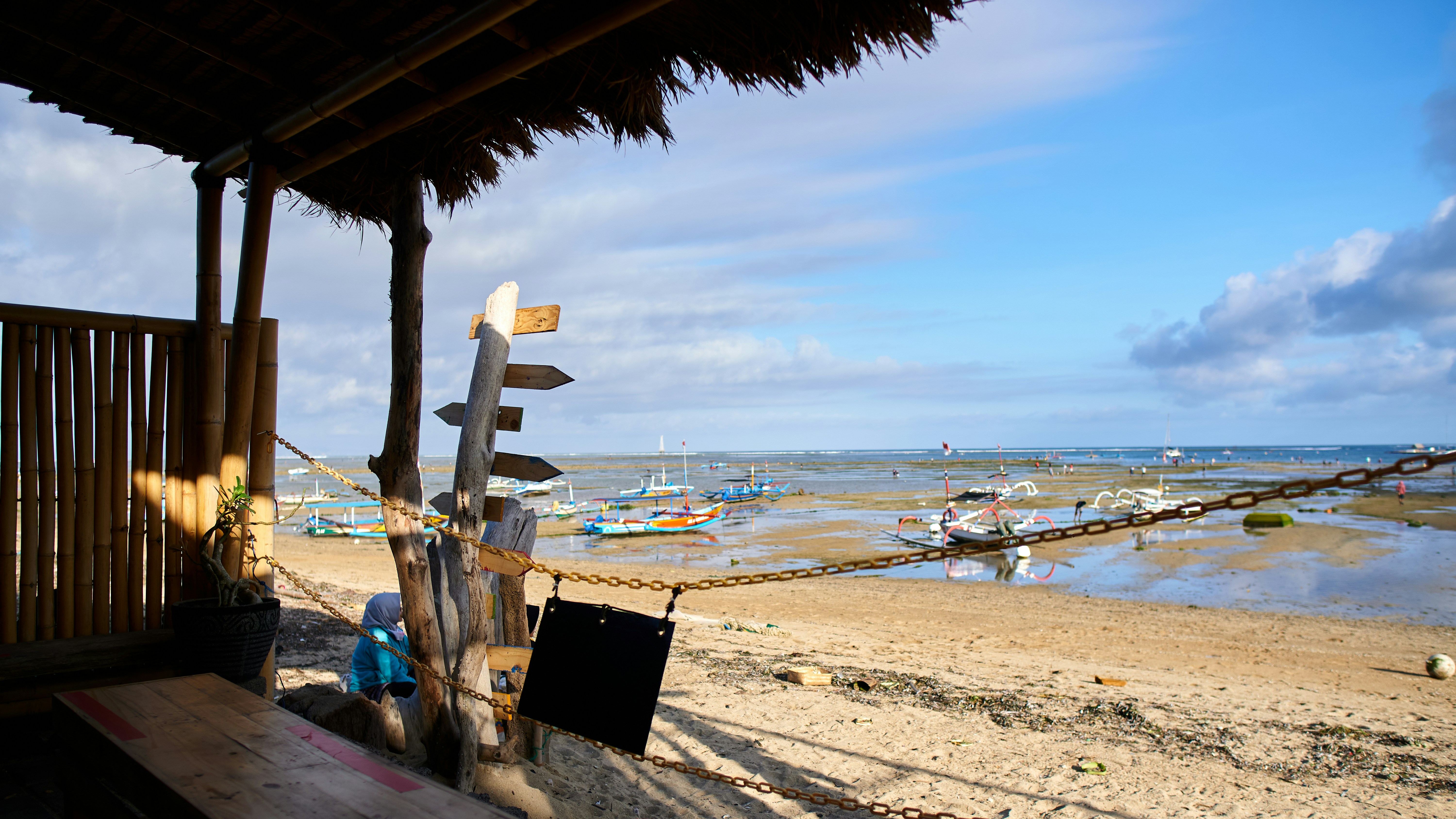 a beach with a bunch of boats in the water