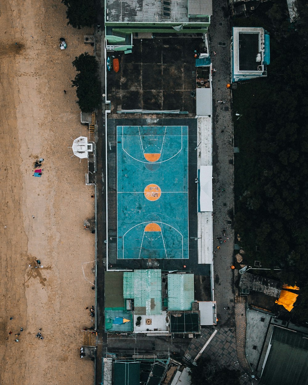 an aerial view of a basketball court in a parking lot
