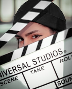 a close up of a person holding a movie clap