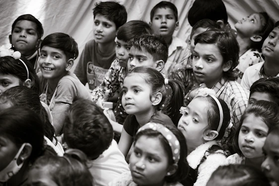 a group of young children sitting next to each other
