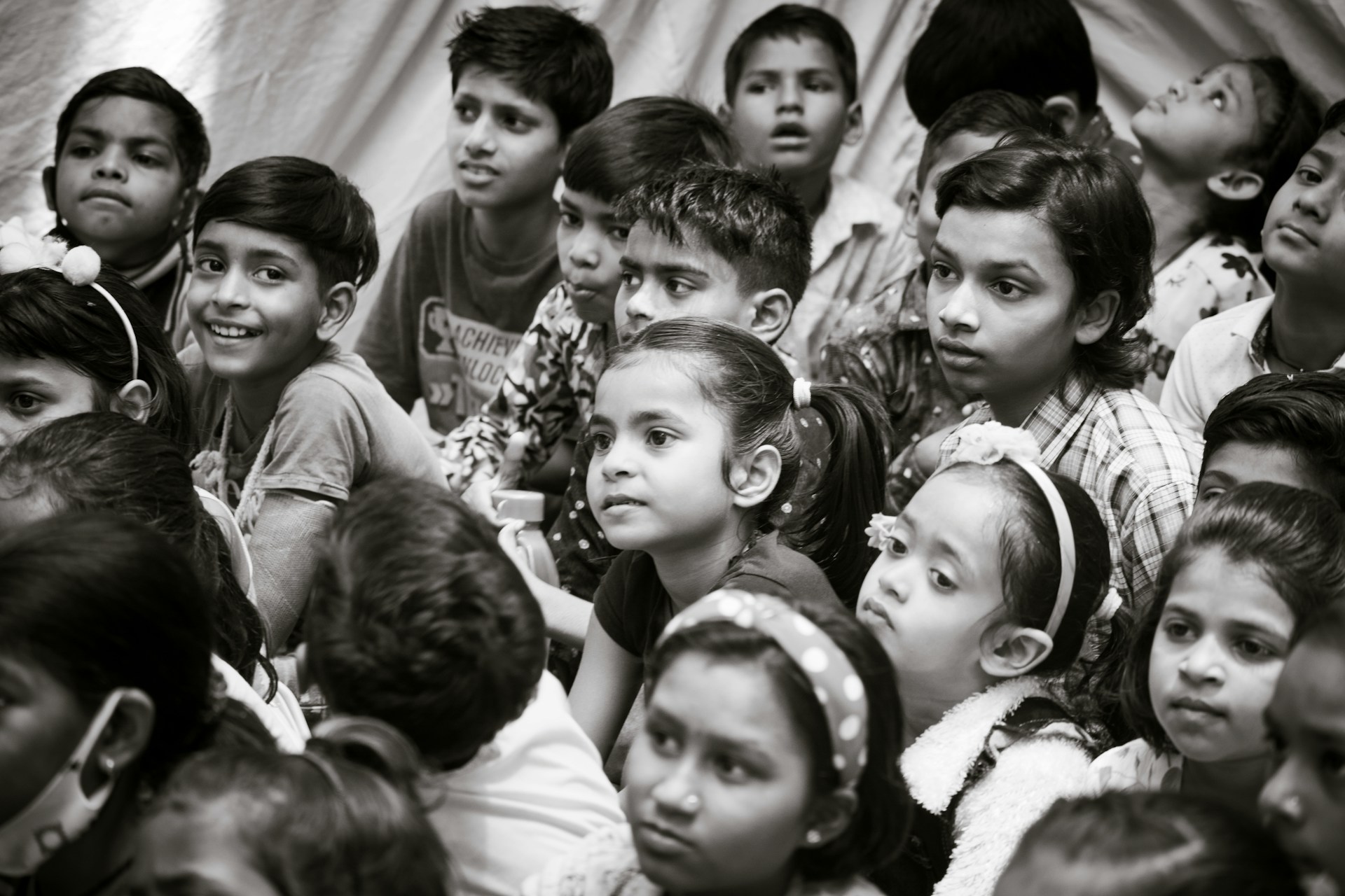 a group of young children sitting next to each other
