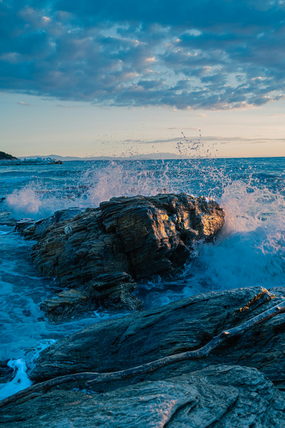 a large body of water near a rocky shore