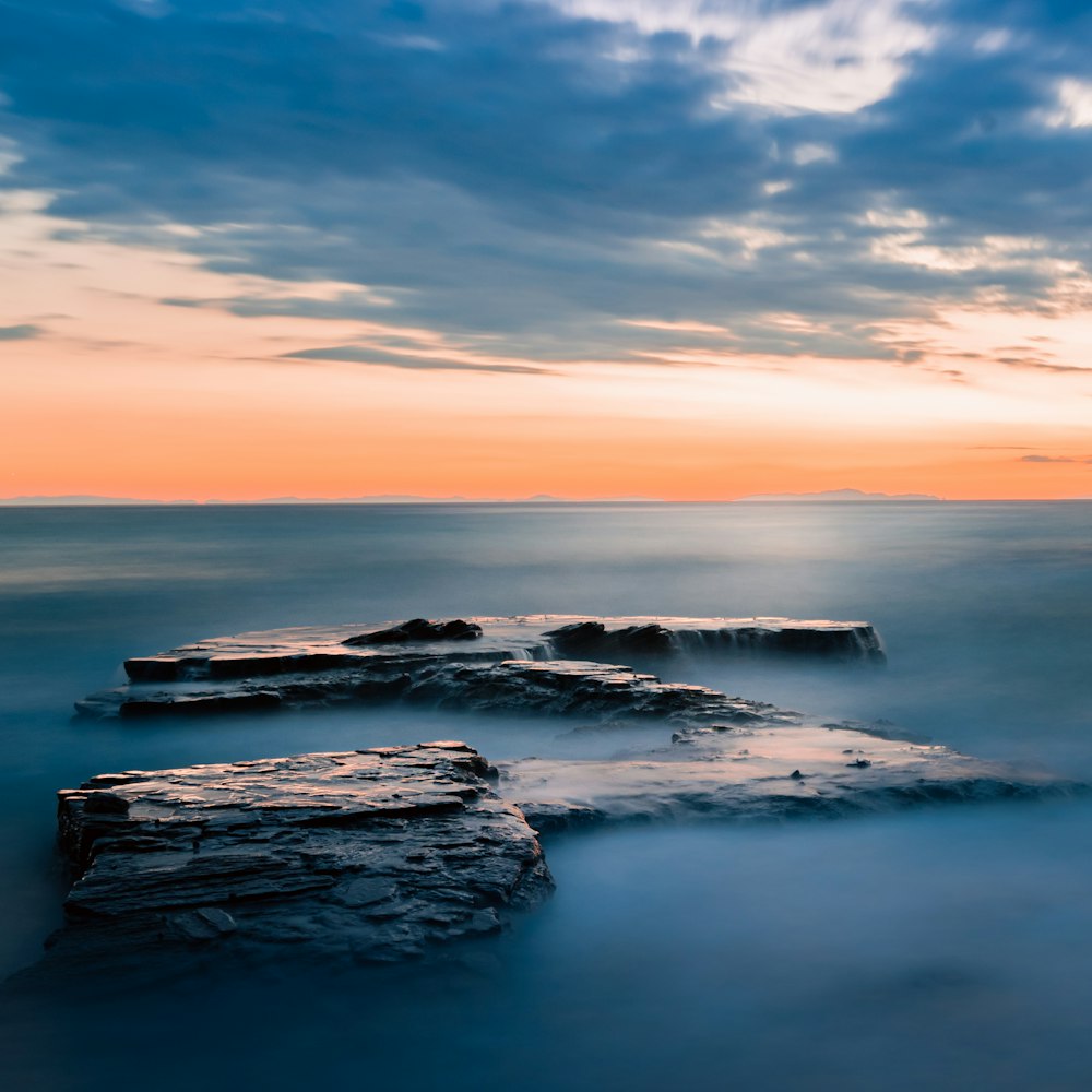 a long exposure of a sunset over the ocean