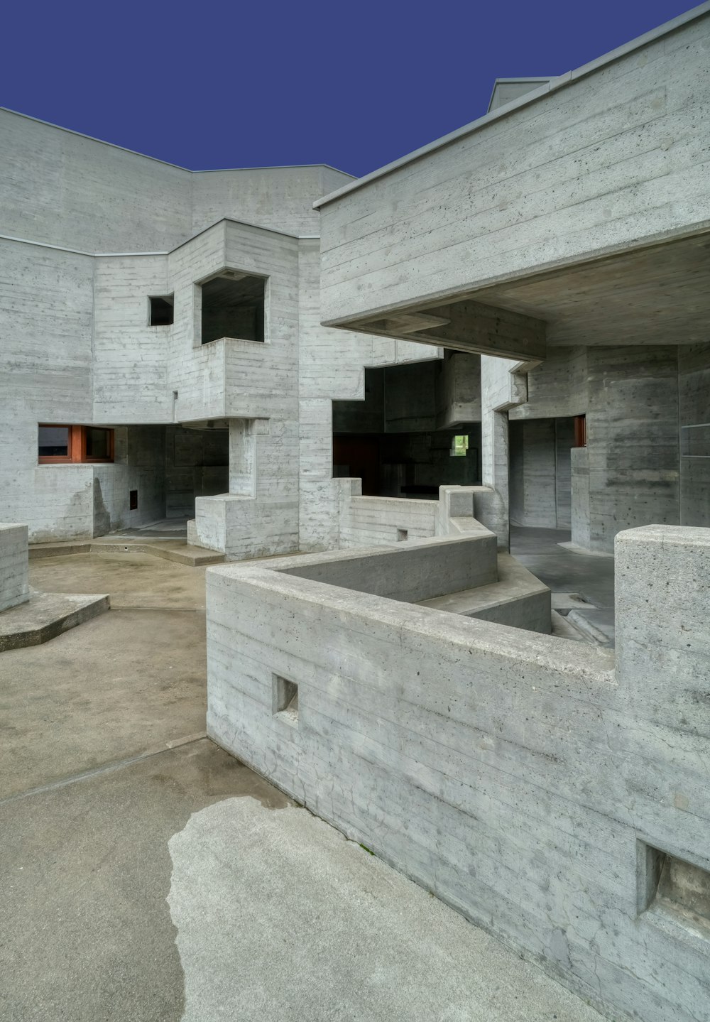 an empty concrete building with a blue sky in the background