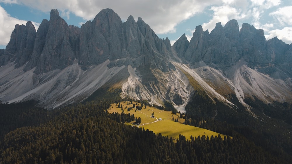 an aerial view of a mountain range with trees