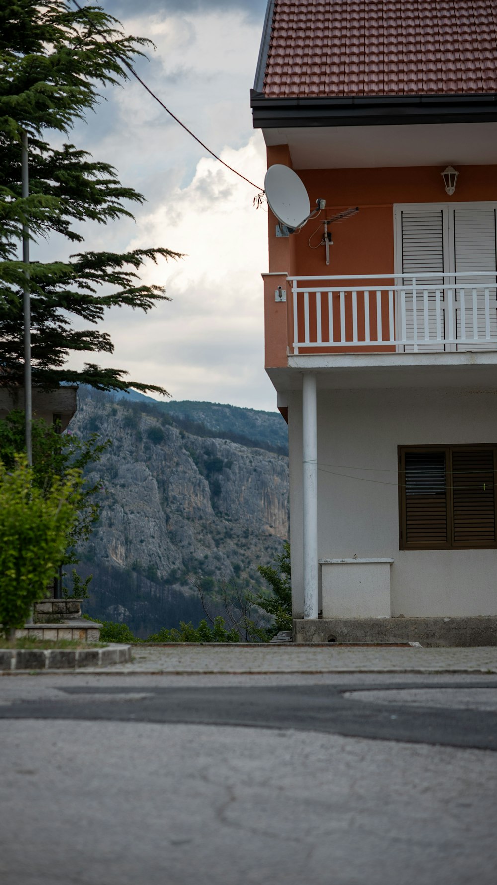 a red and white house with a balcony