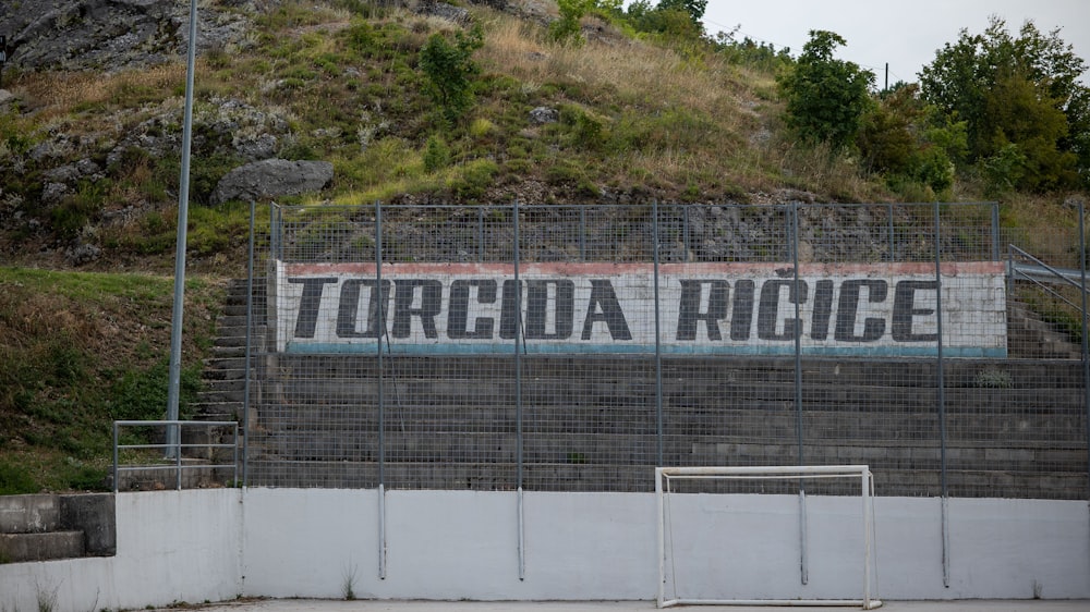 a fenced in area with a sign on it