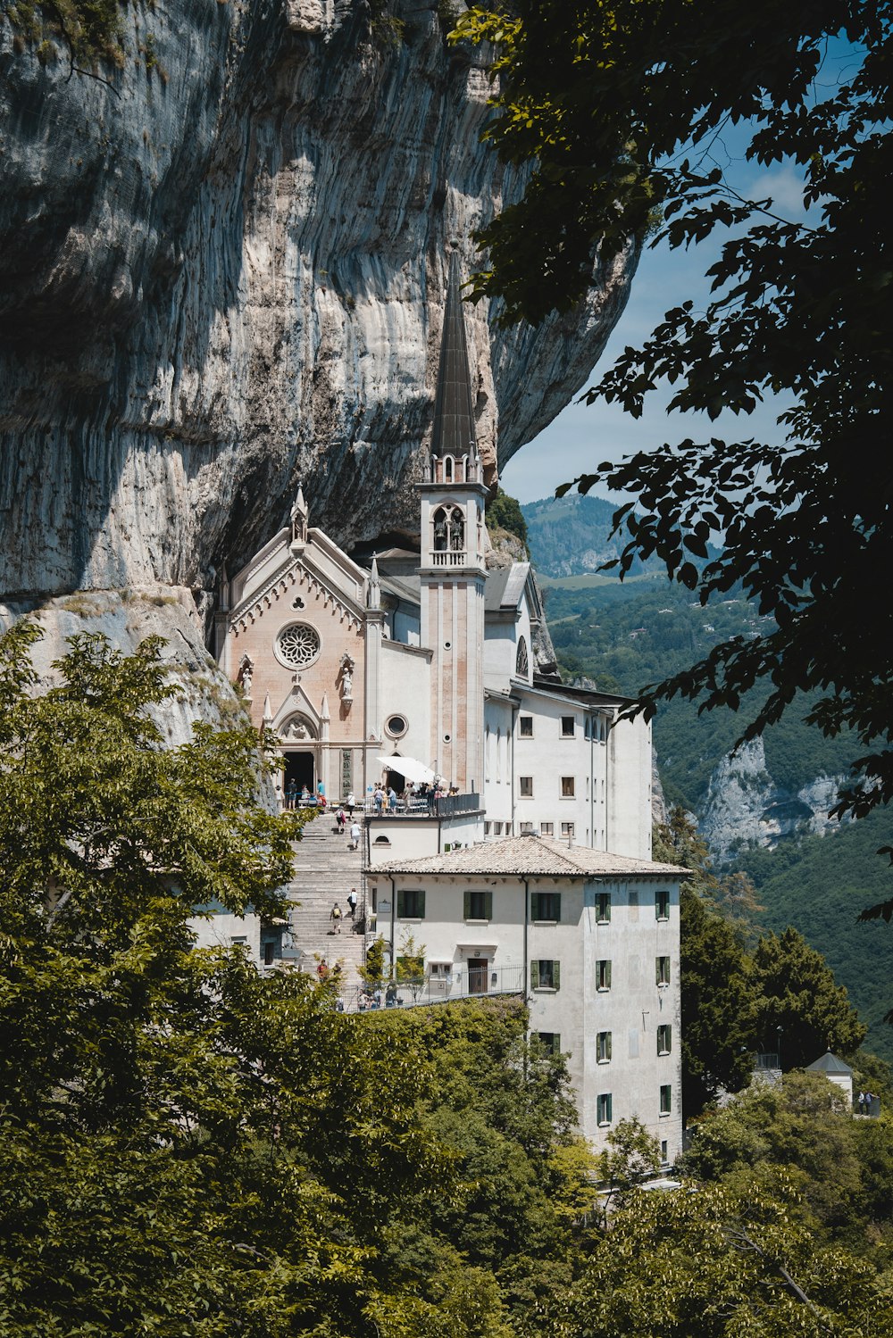 a church on top of a mountain surrounded by trees