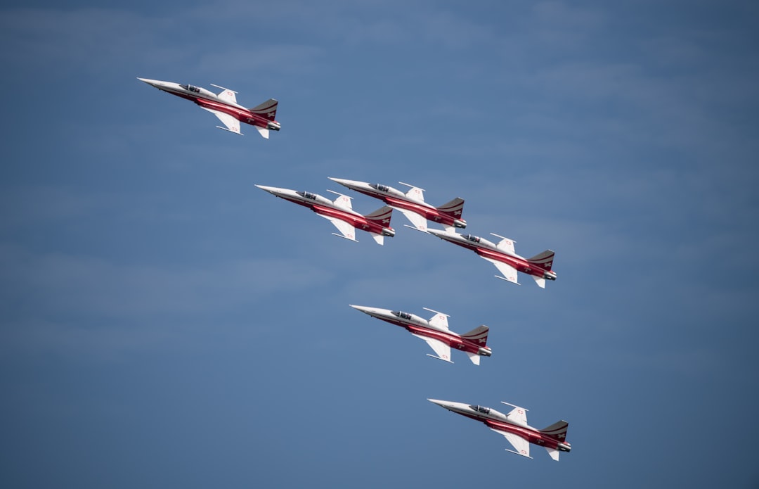 a group of fighter jets flying through a blue sky, Northrop F-5F Tiger II / Patrouille Suisse