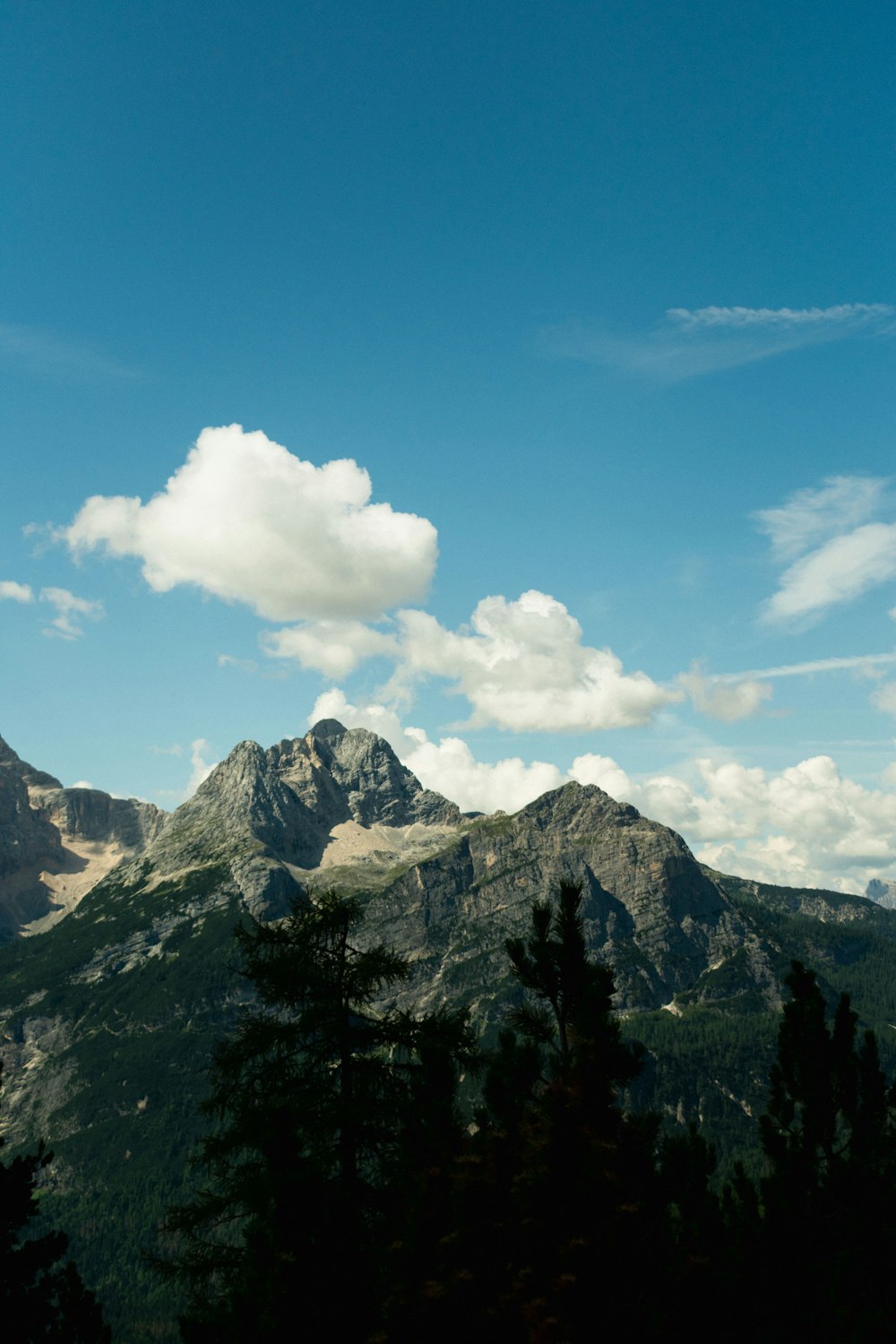 a view of a mountain range with clouds in the sky