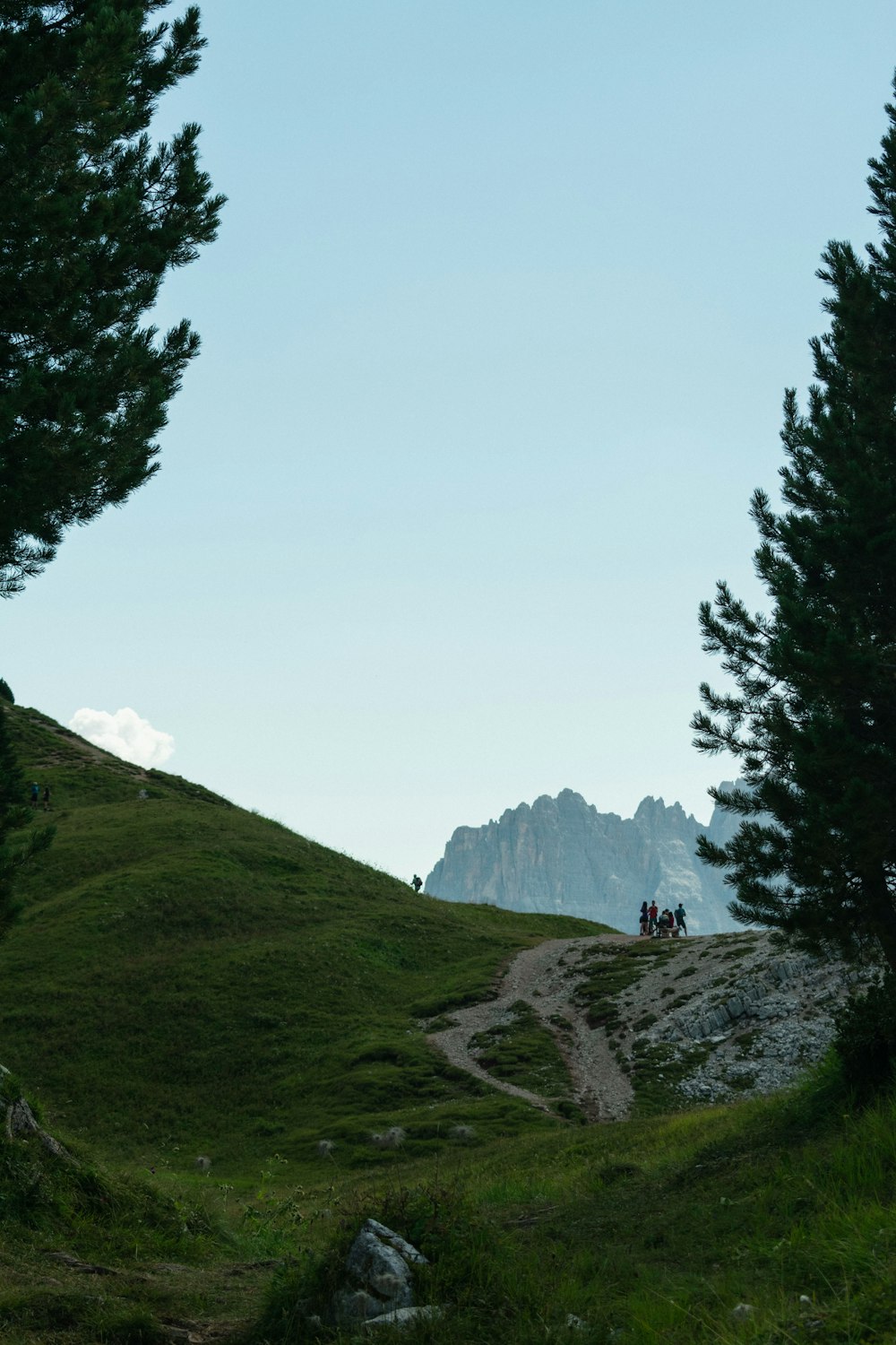 a group of people riding horses down a hill