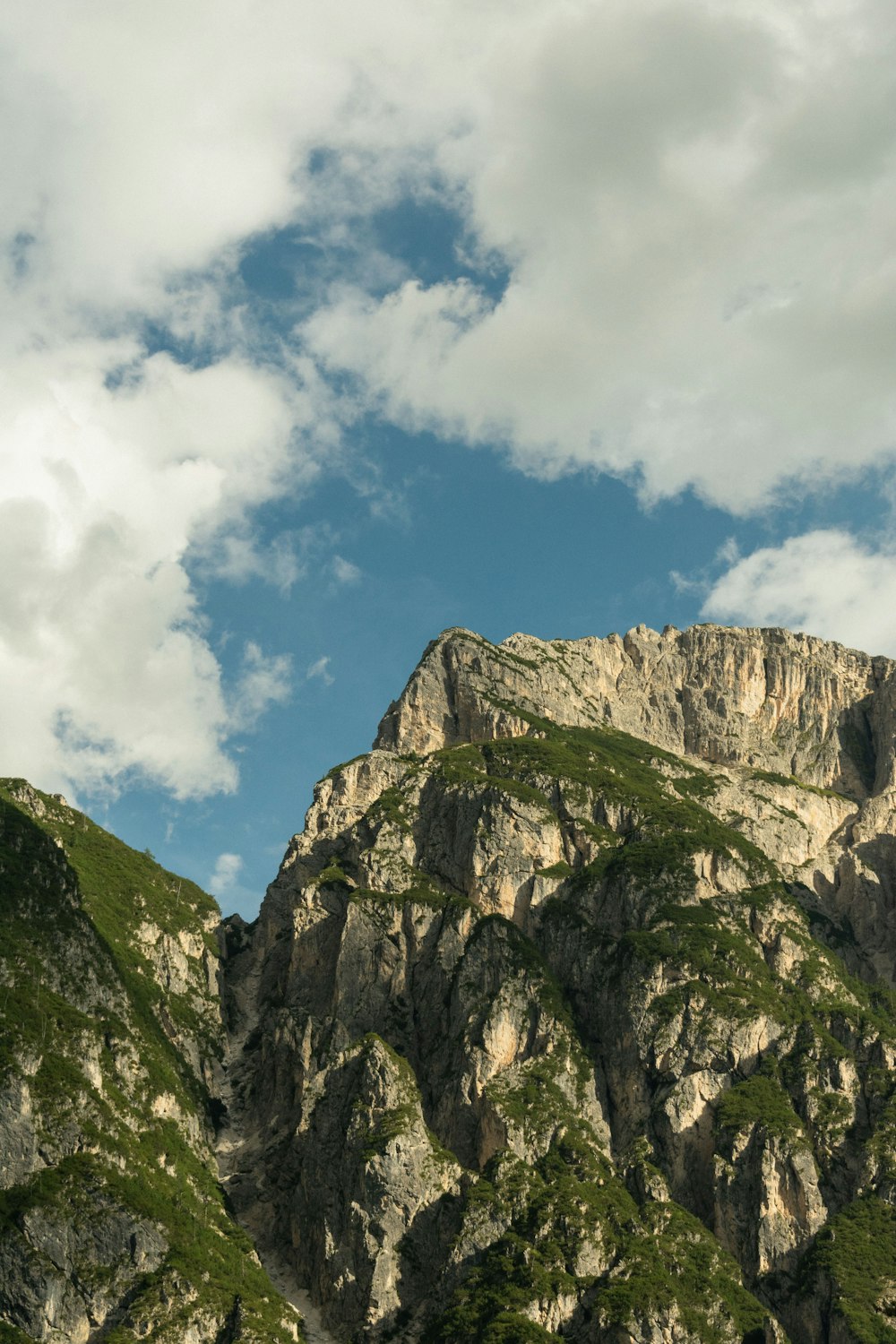 a very tall mountain with a sky in the background