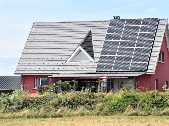 a red house with solar panels on the roof