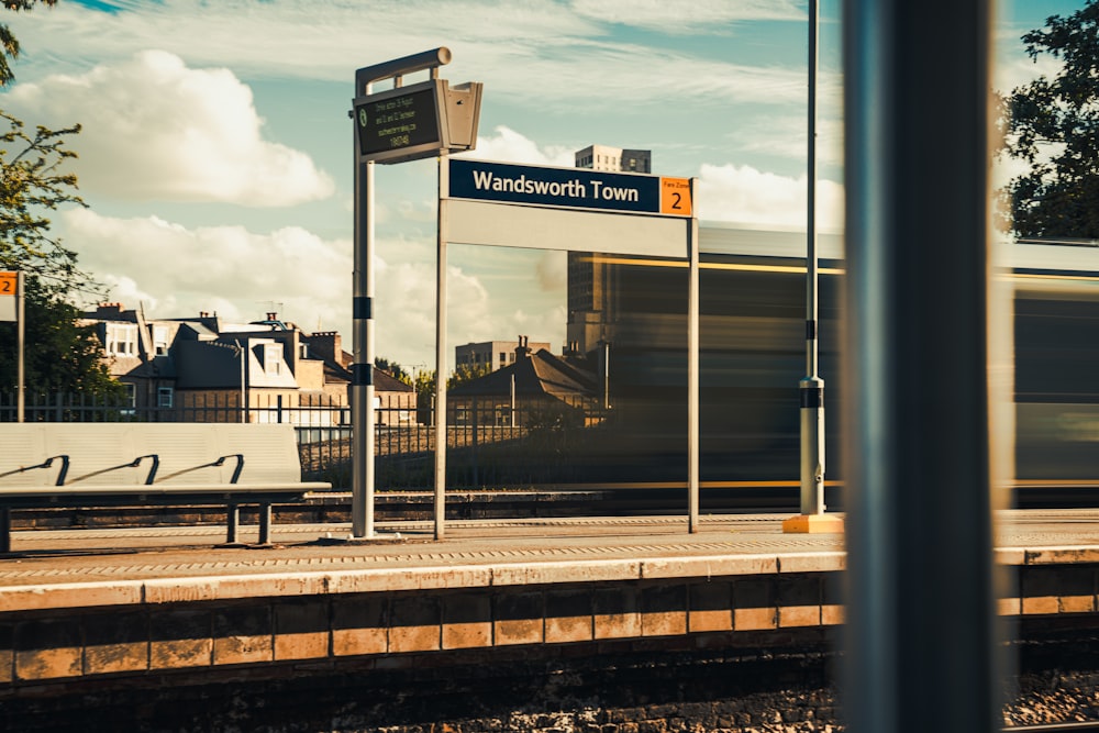 a train traveling down train tracks next to a train station