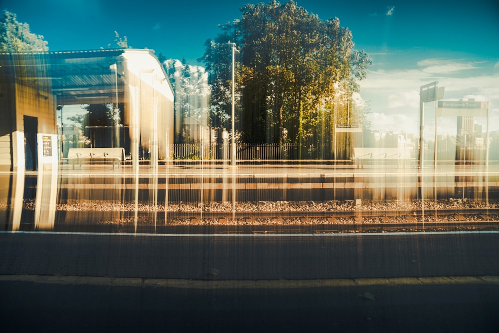 a blurry photo of a train station with trees in the background