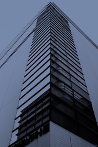 A sleek modern luxury apartment building in Hyderabad with black and gold accents reflecting the brand’s style.