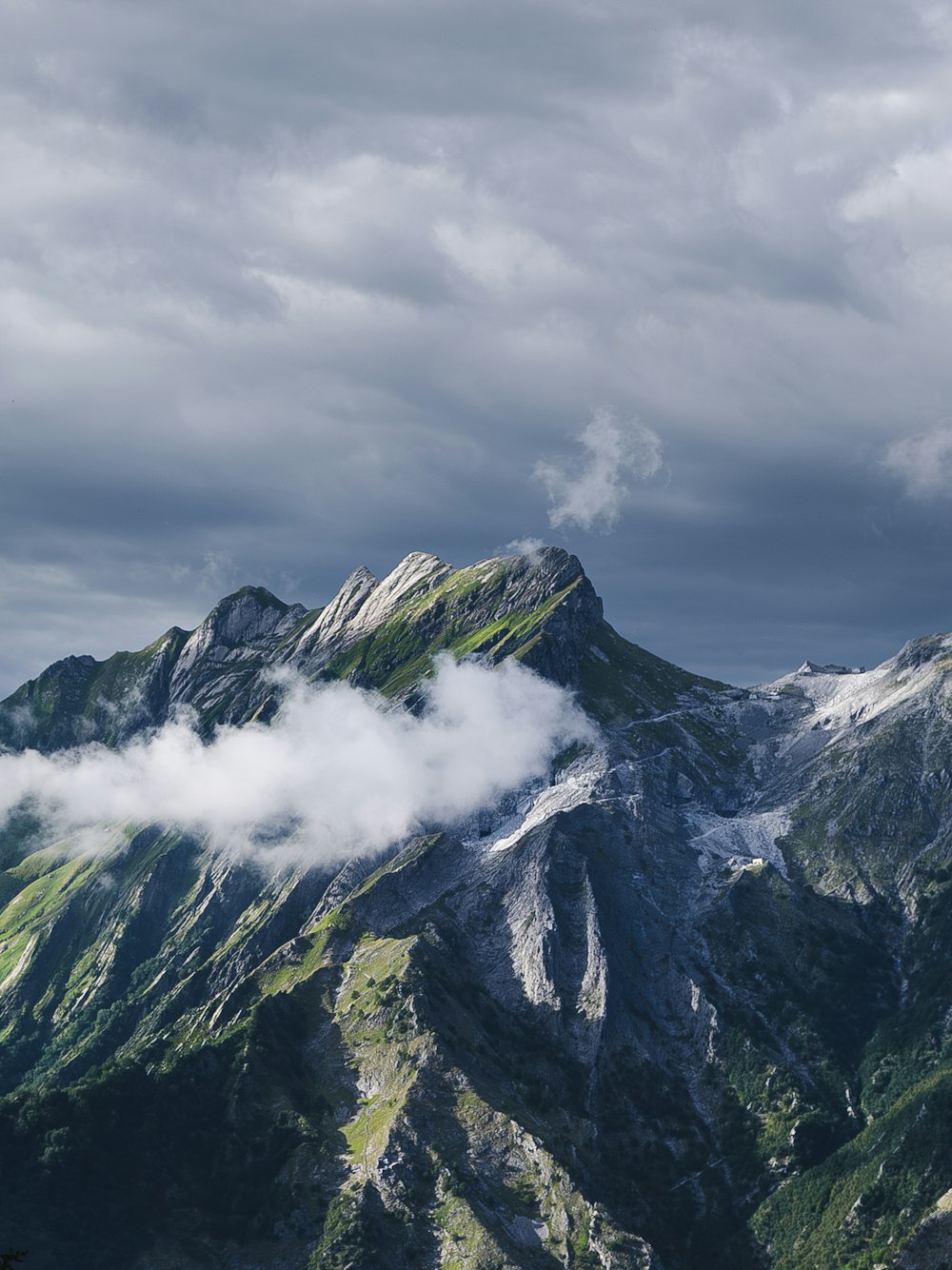 a view of a mountain range with clouds in the sky