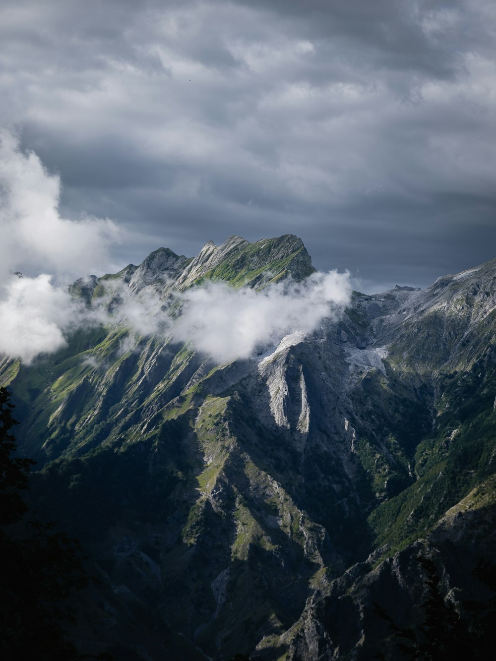 a view of a mountain range with clouds in the sky