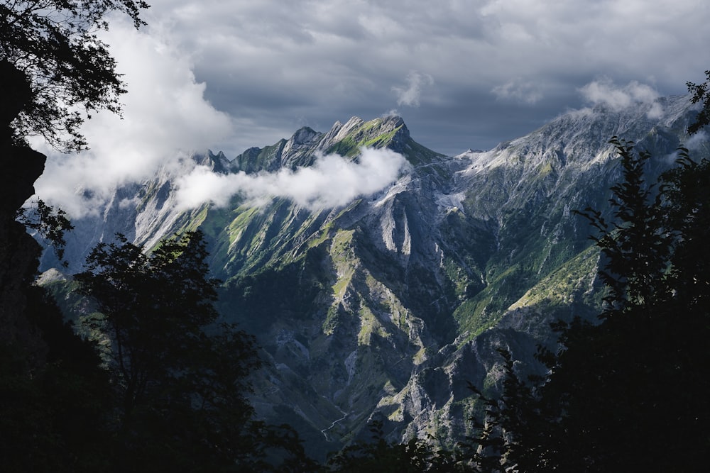 a view of a mountain range with clouds in the sky