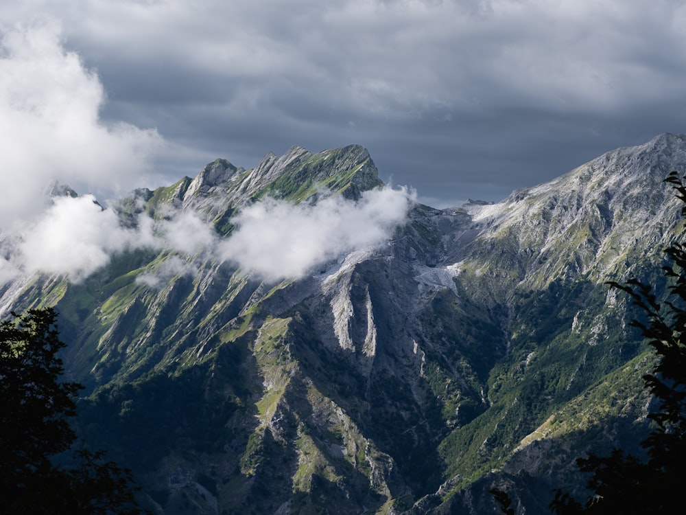 a view of a mountain range with clouds in the sky