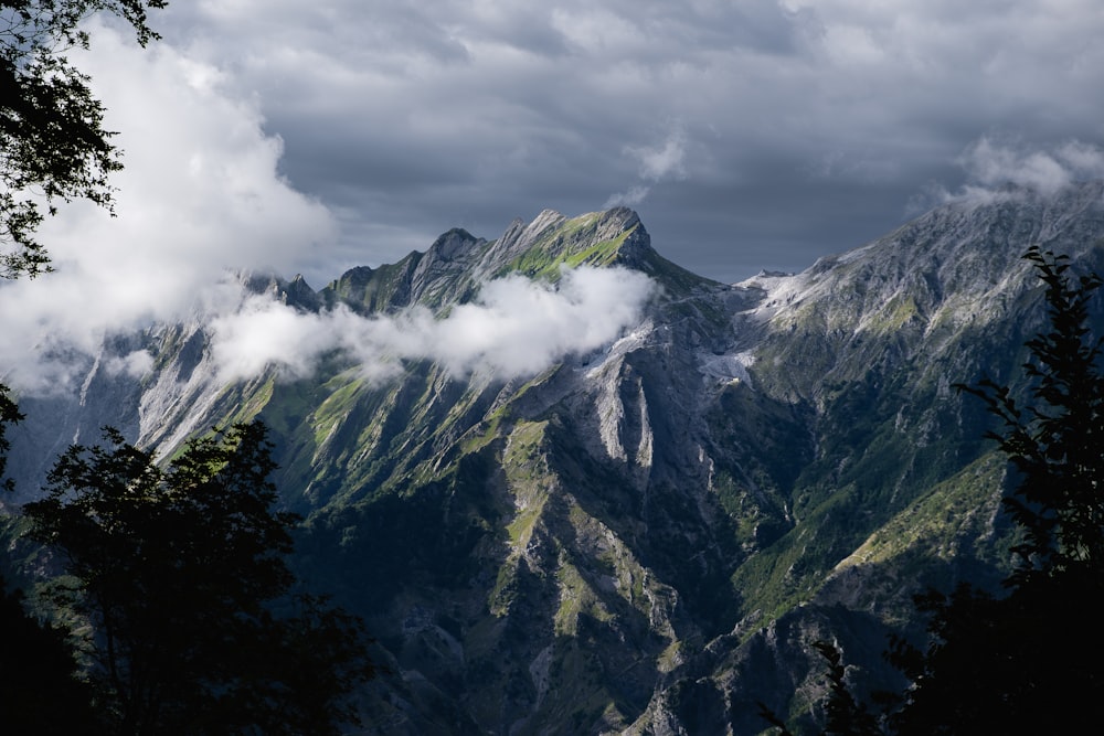 a view of a mountain range with clouds in the sky