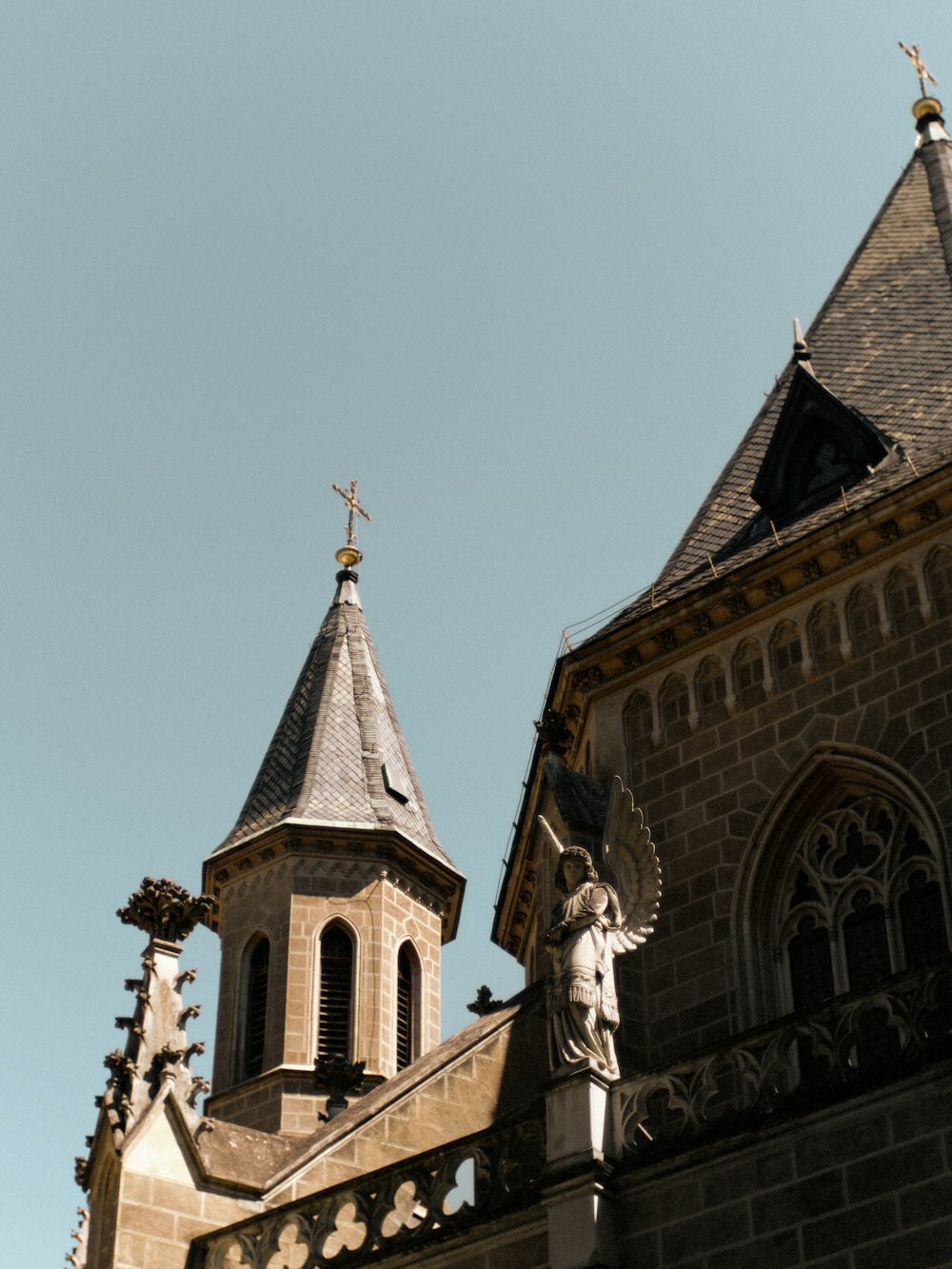 a church steeple with a statue of an angel on top