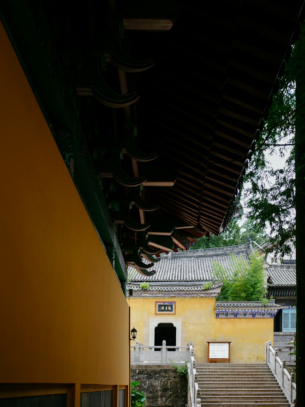 a yellow building with stairs leading up to it