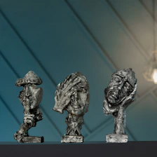 a group of three sculptures sitting on top of a table