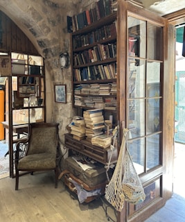 Cozy corner of the cottage with antique books and bundles of wild herbs hanging
