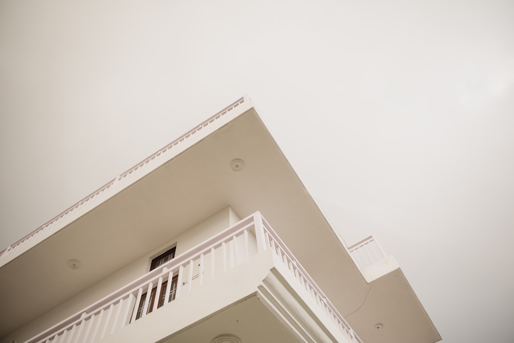 a white building with a balcony and balconies