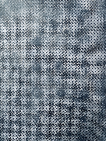 Close-up of interlocking puzzle pieces forming a precise pattern on a deep blue background.