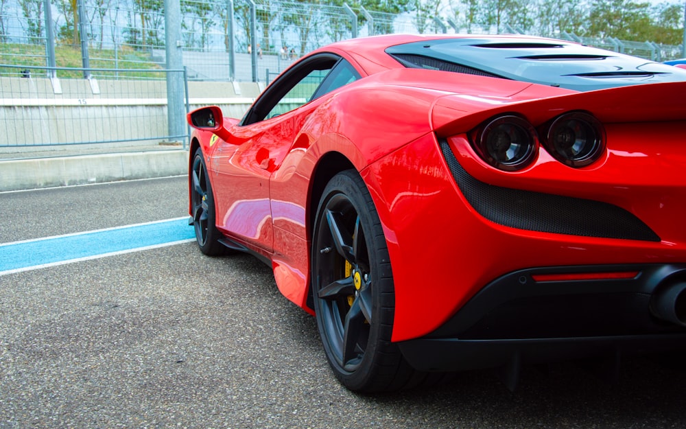 a red sports car parked on the side of the road