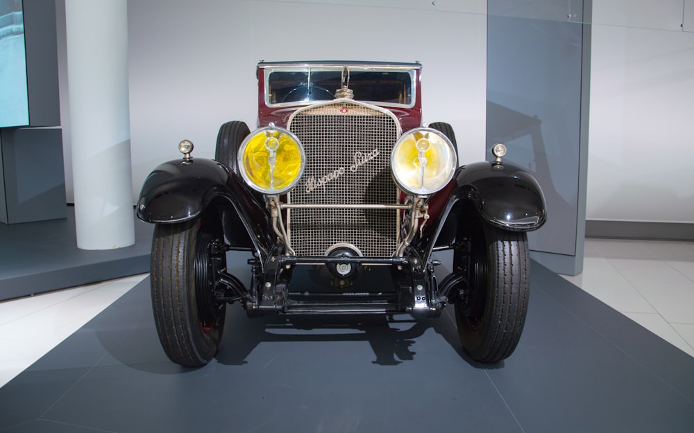 an antique car is on display in a museum