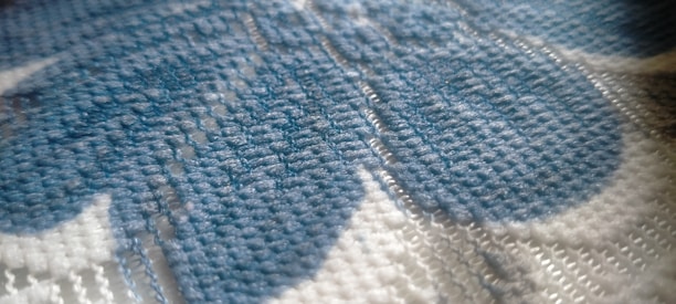 Close-up of soft, high-density fabric with vibrant colors and fine stitching.