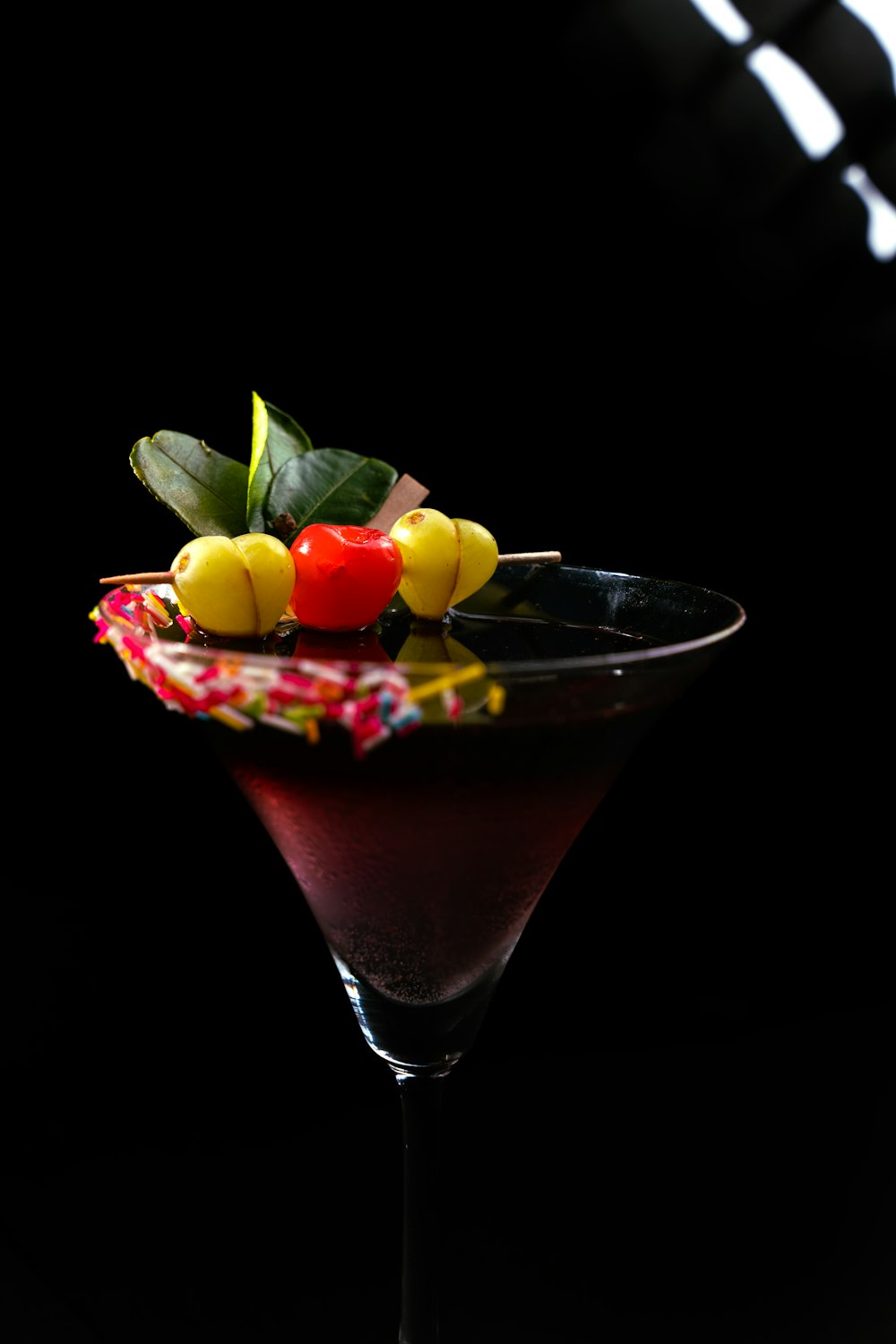 a martini with a cherry garnish and a cherry garnish on the