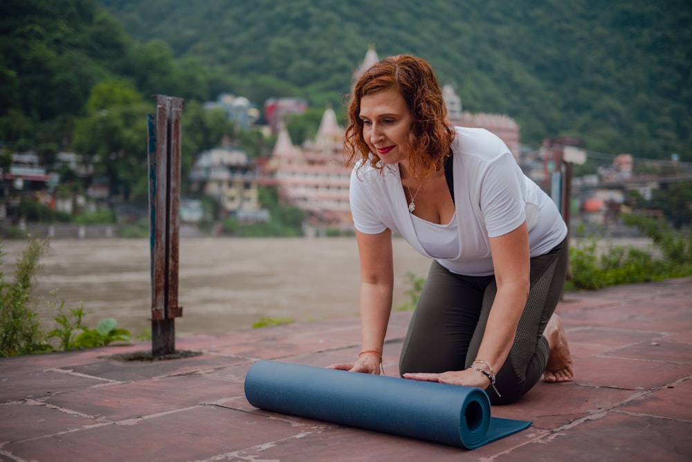 a woman is doing yoga on the ground