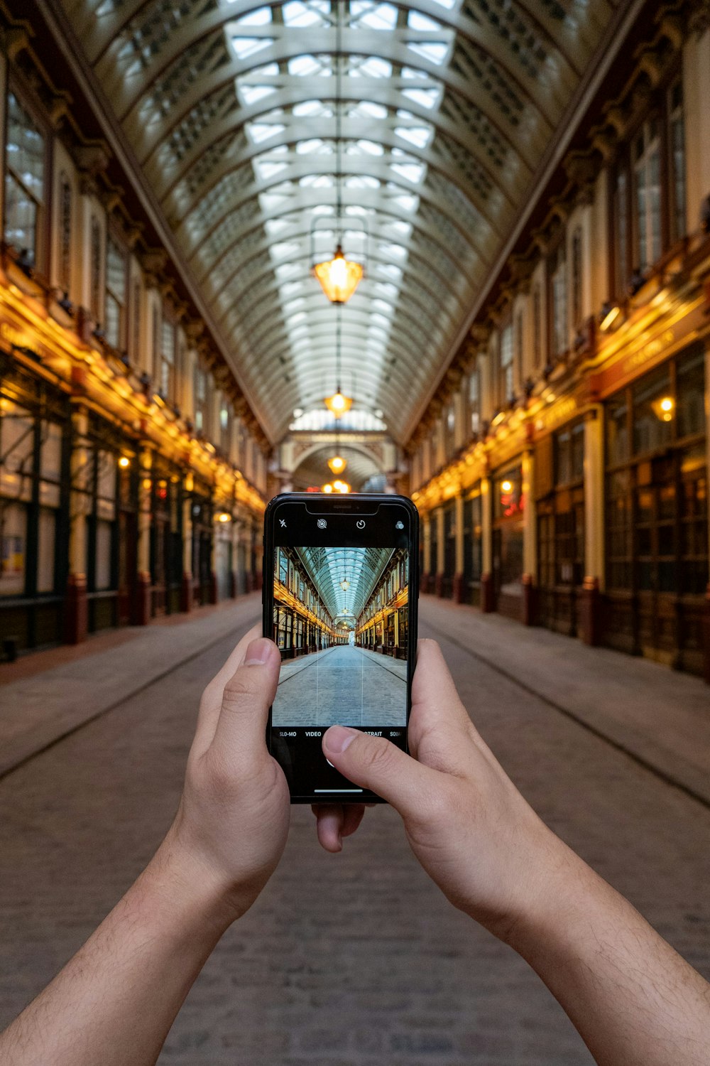 a person taking a picture of a building with a cell phone