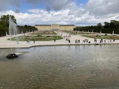 Wide shot of a renovated palace garden with fresh landscaping.