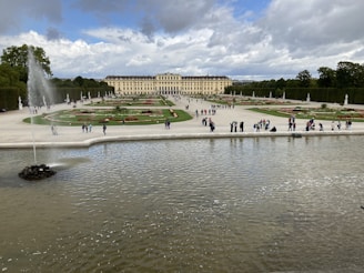 Wide shot of a renovated palace garden with fresh landscaping.