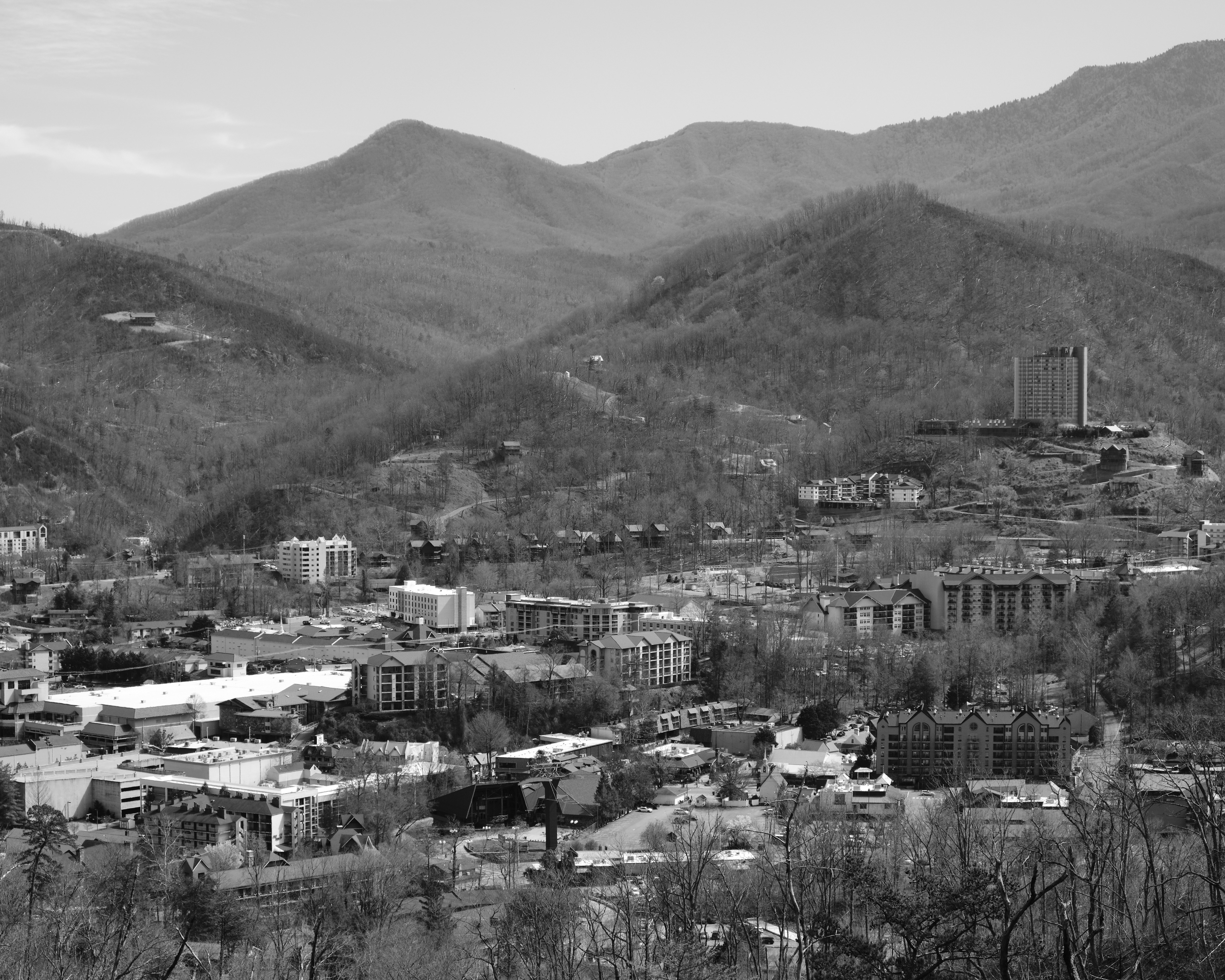 a black and white photo of a city in the mountains